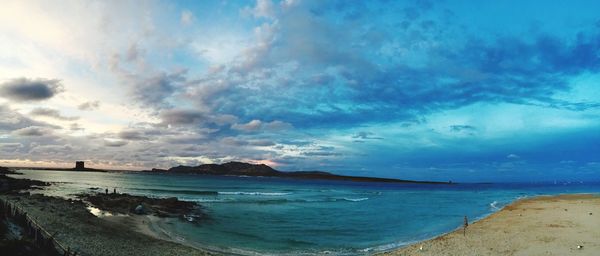 Panoramic view of beach against cloudy sky