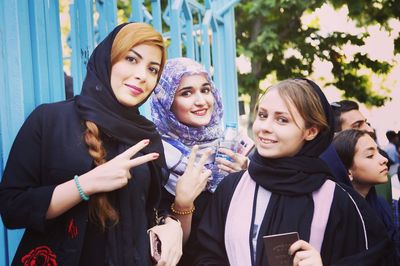 Portrait of smiling young women standing outdoors