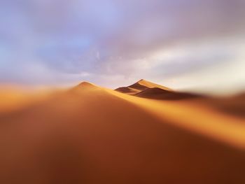 Scenic view of desert against sky during sunset