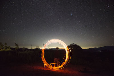 Light trails against sky at night