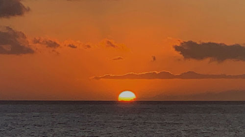 Scenic view of sea against romantic sky at sunset