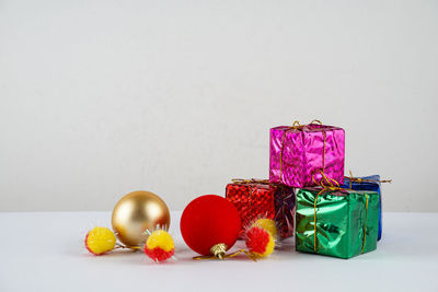 Close-up of multi colored candies on table against white background