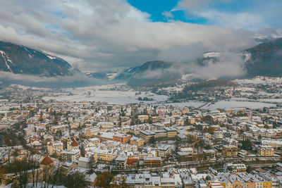 Aerial view of townscape against sky during winter