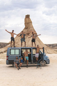 Friends with van enjoying vacation at bardenas reales, navarra, spain