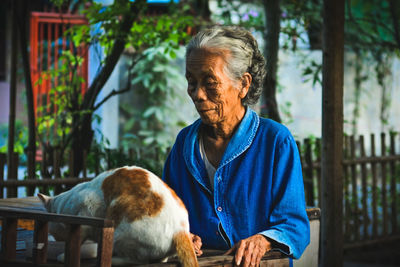 Woman with cat standing by table