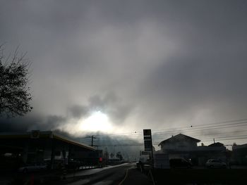 Road in city against sky at night