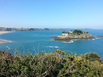 Scenic view of sea against clear blue sky