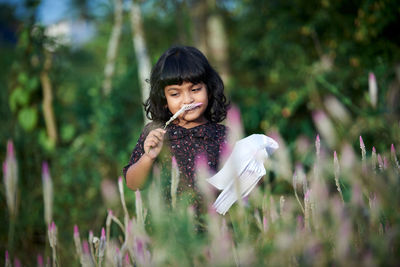 Portrait of girl holding plant