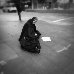 Full length of woman standing by railing
