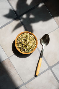 Bowl of organic hemp seed on tiled surface. healthy plant based superfood ingredient for vegan diet 