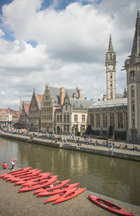 Boats in canal amidst buildings in city