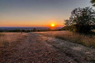 Scenic view of field against sky during sunset