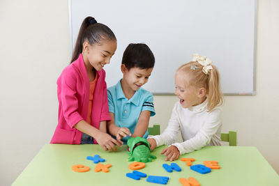 Kids playing with toy at classroom