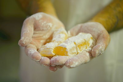 Close-up of hands holding turkish delight