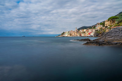 Scenic view of sea against sky in city