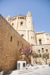 Low angle view of historic building against clear blue sky