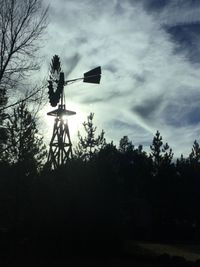 Low angle view of silhouette statue against sky