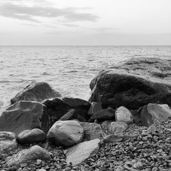 Rocks on beach against sky