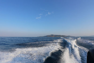 Scenic view of sea against clear blue sky