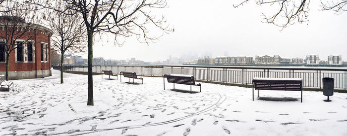 Snow covered city against clear sky