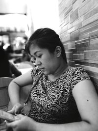 Close-up of woman sitting outdoors