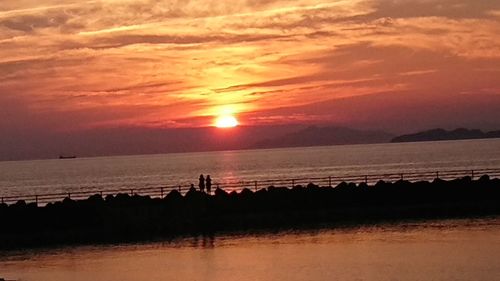 Scenic view of sea against sky at sunset