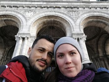 Low angle view of couple against historic building