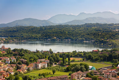 High angle view of townscape by mountains against sky