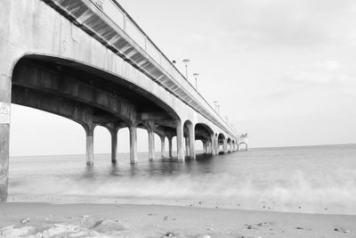 Bridge over sea against sky