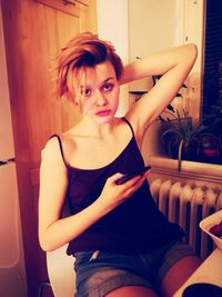Portrait of woman sitting at home