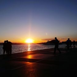 People on beach at sunset