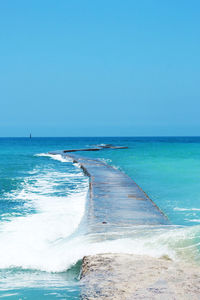 Scenic view of sea against clear blue sky