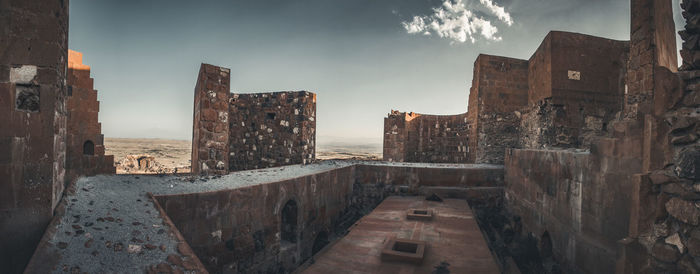 View of old building against cloudy sky