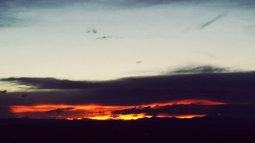 Scenic view of silhouette mountain against sky at sunset