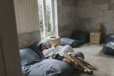 Couple hugging on beanbags