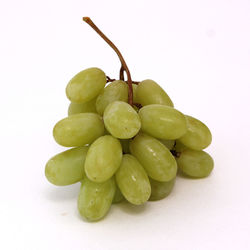 Close-up of grapes in bowl against white background