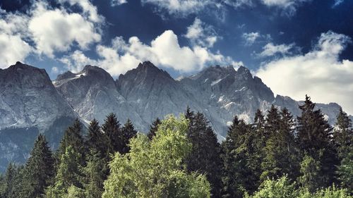 Scenic view of mountains against cloudy sky