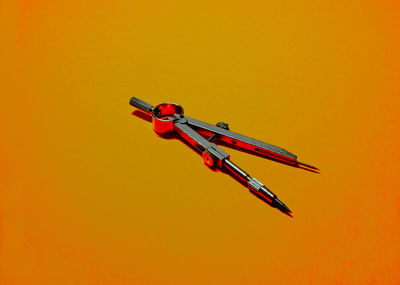 Close-up of red toy on yellow background