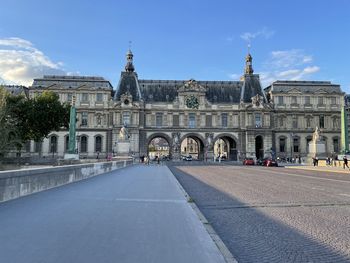 One of the many beautiful entrances to the louvre, as seen from a bridge leading into it.