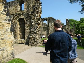 Rear view of man looking at old ruins