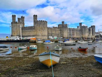 Caernarfon castle viewed across a river. caernarfon. gwynedd. wales.uk