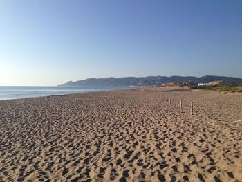 Scenic view of beach against clear sky