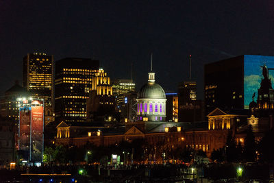 Illuminated buildings in city at night