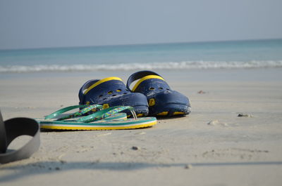 Flip-flop by shoe at beach