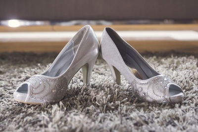 Close-up of high heels on rug