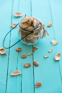 High angle view of apricot seeds in jar on table