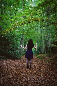 Woman standing in forest