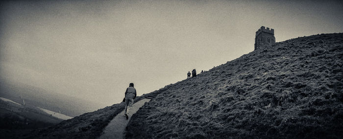 Low angle view of person standing on cliff