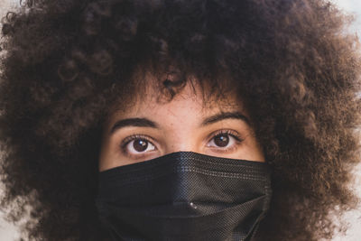 Close-up portrait of mid adult man covering face