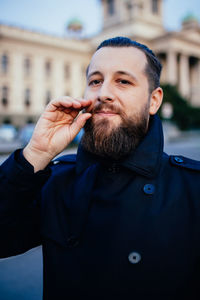 Portrait of man against buildings